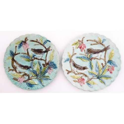 84 - A pair of French majolica plates with relief decoration depicting birds, berries and leaves. Approx.... 