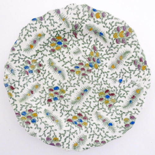 85 - A 19thC plate with transfer printed fern decoration and hand painted floral detail. Approx. 8 1/2
