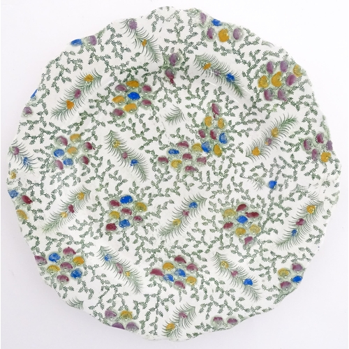 85 - A 19thC plate with transfer printed fern decoration and hand painted floral detail. Approx. 8 1/2