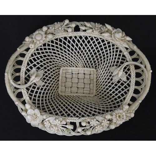 109 - A Belleek four strand Henshall Basket having lattice work with ribbon edges, decorated with flowers ... 