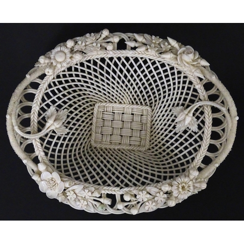 109 - A Belleek four strand Henshall Basket having lattice work with ribbon edges, decorated with flowers ... 