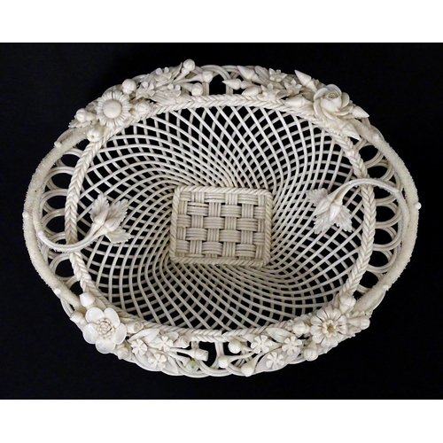 109 - A Belleek four strand Henshall Basket having lattice work with ribbon edges, decorated with flowers ... 