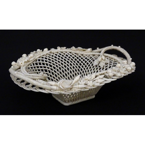 109 - A Belleek four strand Henshall Basket having lattice work with ribbon edges, decorated with flowers ... 