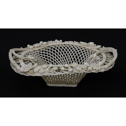 109 - A Belleek four strand Henshall Basket having lattice work with ribbon edges, decorated with flowers ... 
