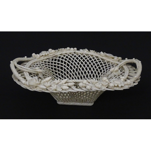 109 - A Belleek four strand Henshall Basket having lattice work with ribbon edges, decorated with flowers ... 