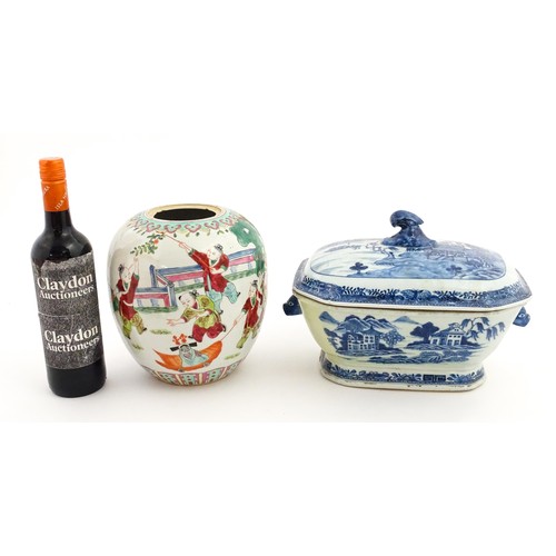 70A - An 18thC Chinese export blue and white lidded tureen decorated with a river landscape with trees and... 
