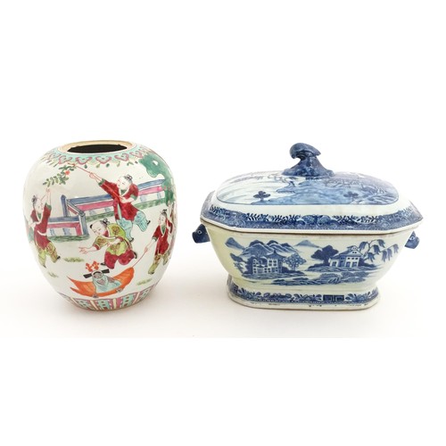 70A - An 18thC Chinese export blue and white lidded tureen decorated with a river landscape with trees and... 