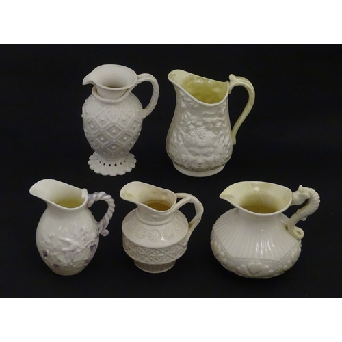 100 - Five Belleek jugs to include Institute creamer with seahorse handle, Rope Handle jug, Bacchus Mask, ... 