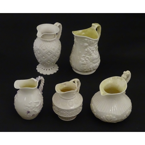 100 - Five Belleek jugs to include Institute creamer with seahorse handle, Rope Handle jug, Bacchus Mask, ... 