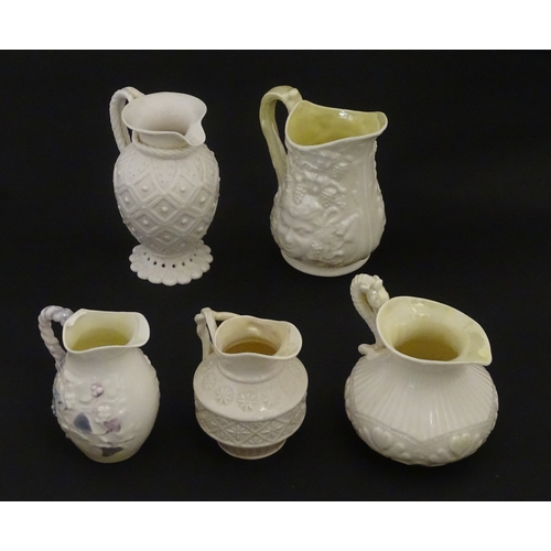 100 - Five Belleek jugs to include Institute creamer with seahorse handle, Rope Handle jug, Bacchus Mask, ... 