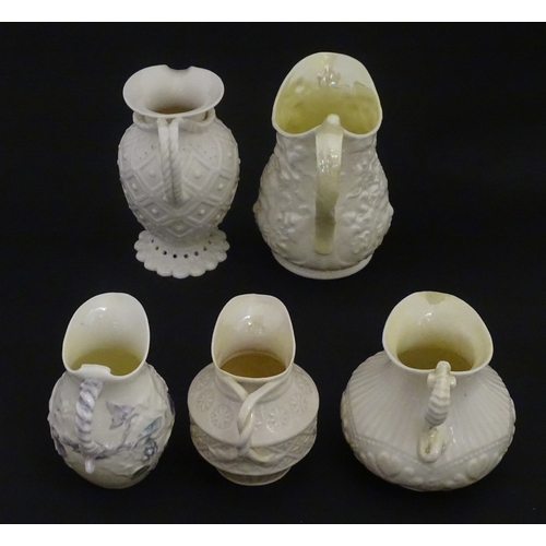 100 - Five Belleek jugs to include Institute creamer with seahorse handle, Rope Handle jug, Bacchus Mask, ... 