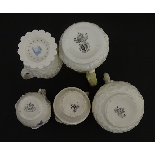 100 - Five Belleek jugs to include Institute creamer with seahorse handle, Rope Handle jug, Bacchus Mask, ... 