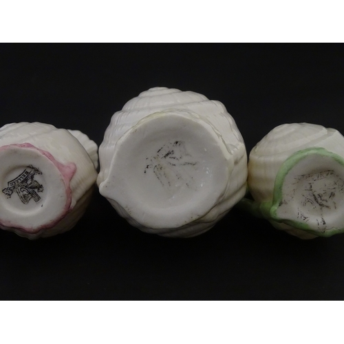 102 - Four Belleek Nautilus Shell creamers / milk jugs, to include three toy creamers with painted highlig... 