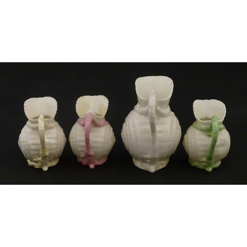 102 - Four Belleek Nautilus Shell creamers / milk jugs, to include three toy creamers with painted highlig... 