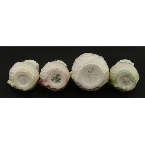 102 - Four Belleek Nautilus Shell creamers / milk jugs, to include three toy creamers with painted highlig... 