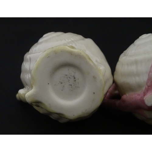 102 - Four Belleek Nautilus Shell creamers / milk jugs, to include three toy creamers with painted highlig... 