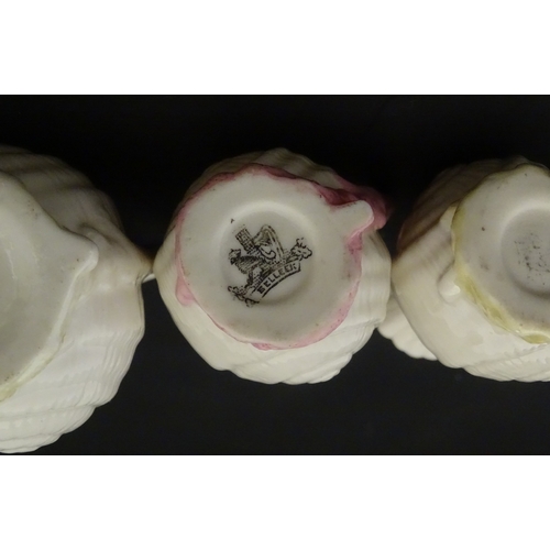 102 - Four Belleek Nautilus Shell creamers / milk jugs, to include three toy creamers with painted highlig... 