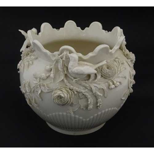 103 - A Belleek Rathmore jardiniere / planter decorated with birds, flowers and foliage. Marked with Secon... 