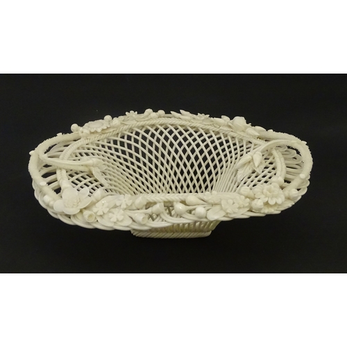 104 - A Belleek four strand basket of oval form with flower and foliate detail to rim. Bearing impressed m... 