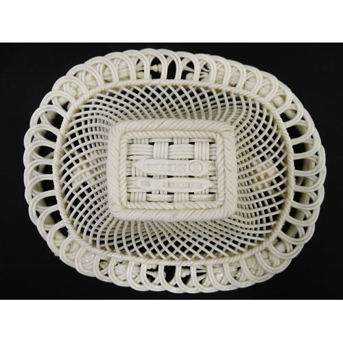 104 - A Belleek four strand basket of oval form with flower and foliate detail to rim. Bearing impressed m... 