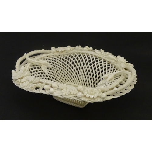 104 - A Belleek four strand basket of oval form with flower and foliate detail to rim. Bearing impressed m... 