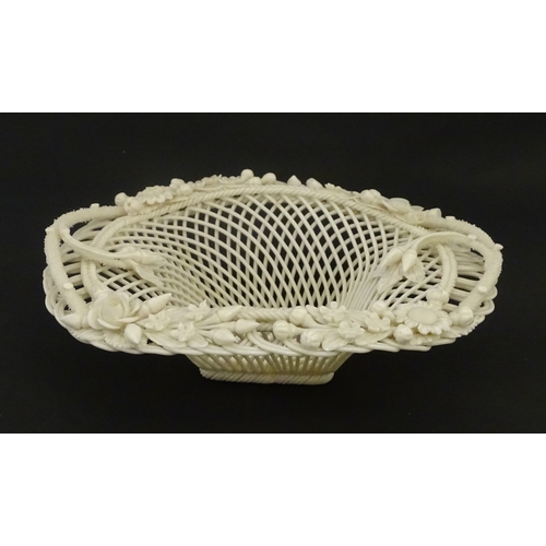 104 - A Belleek four strand basket of oval form with flower and foliate detail to rim. Bearing impressed m... 
