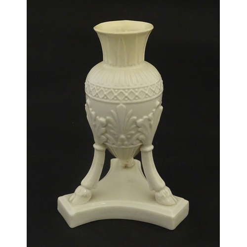 107 - A Belleek Amphora vase on tripod support with hoof feet. Bearing First Period mark under. Approx. 6 ... 