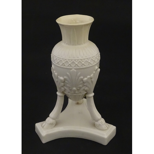 107 - A Belleek Amphora vase on tripod support with hoof feet. Bearing First Period mark under. Approx. 6 ... 