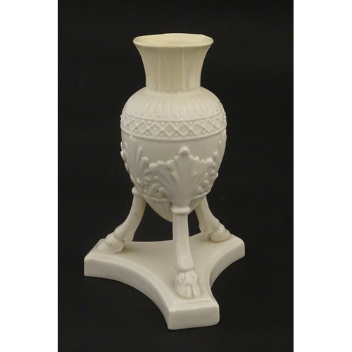 107 - A Belleek Amphora vase on tripod support with hoof feet. Bearing First Period mark under. Approx. 6 ... 