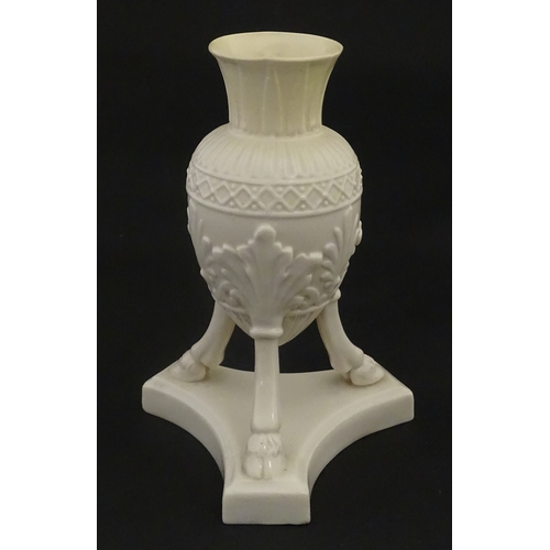 107 - A Belleek Amphora vase on tripod support with hoof feet. Bearing First Period mark under. Approx. 6 ... 
