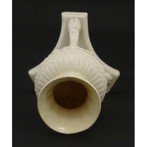 107 - A Belleek Amphora vase on tripod support with hoof feet. Bearing First Period mark under. Approx. 6 ... 
