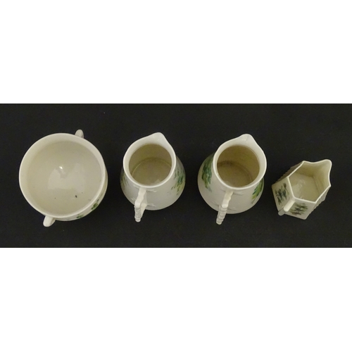 108 - Five items of Belleek porcelain decorated with hand painted shamrock detail to include a sugar bowl,... 