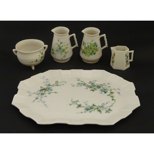 108 - Five items of Belleek porcelain decorated with hand painted shamrock detail to include a sugar bowl,... 