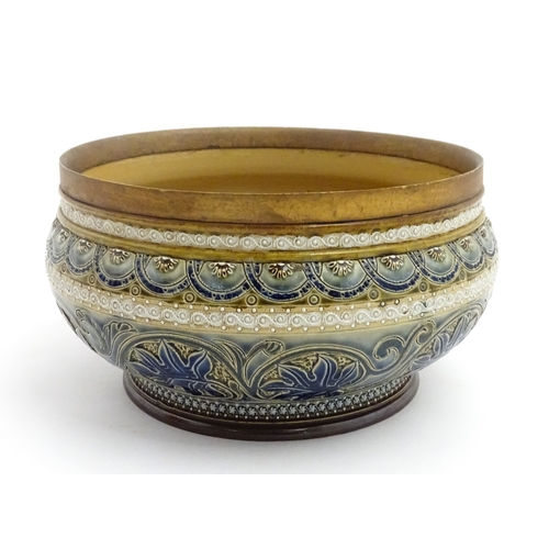 111 - A Doulton Lambeth stoneware bowl decorated with scrolling foliate detail and banded decoration. Mark... 