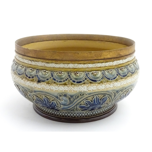 111 - A Doulton Lambeth stoneware bowl decorated with scrolling foliate detail and banded decoration. Mark... 
