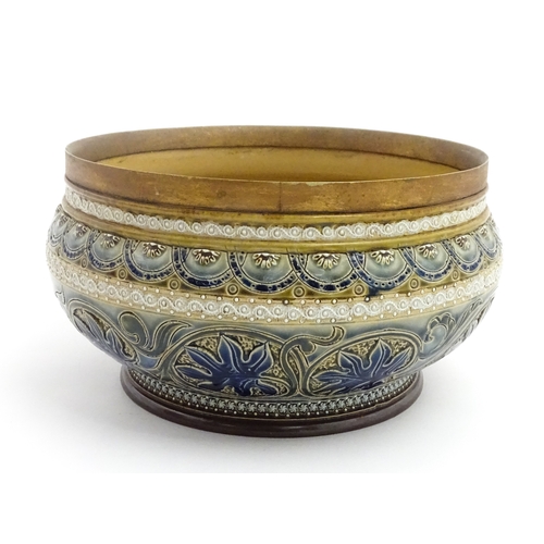 111 - A Doulton Lambeth stoneware bowl decorated with scrolling foliate detail and banded decoration. Mark... 
