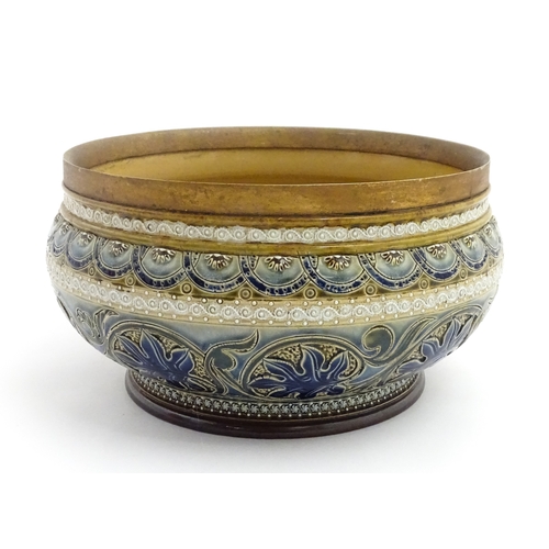 111 - A Doulton Lambeth stoneware bowl decorated with scrolling foliate detail and banded decoration. Mark... 