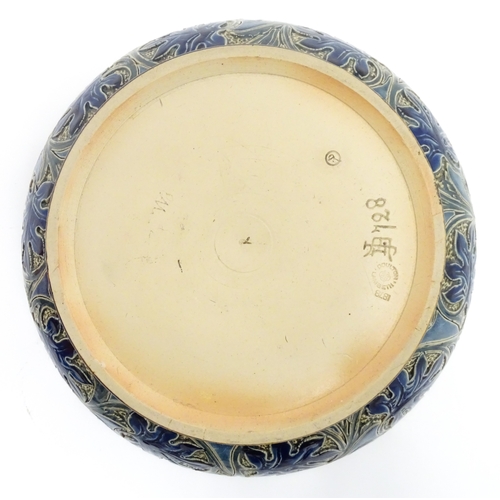 111 - A Doulton Lambeth stoneware bowl decorated with scrolling foliate detail and banded decoration. Mark... 