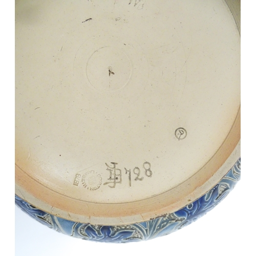 111 - A Doulton Lambeth stoneware bowl decorated with scrolling foliate detail and banded decoration. Mark... 