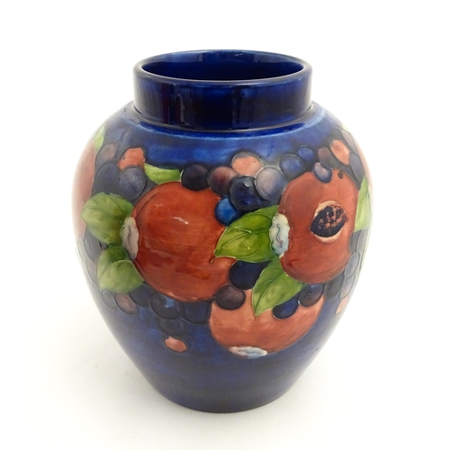 112 - A Moorcroft ginger jar decorated in the Pomegranate pattern. Marked under. Approx. 9 3/4