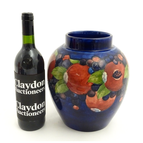 112 - A Moorcroft ginger jar decorated in the Pomegranate pattern. Marked under. Approx. 9 3/4