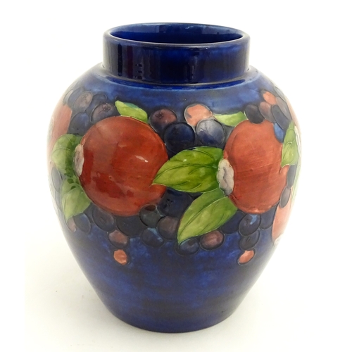 112 - A Moorcroft ginger jar decorated in the Pomegranate pattern. Marked under. Approx. 9 3/4