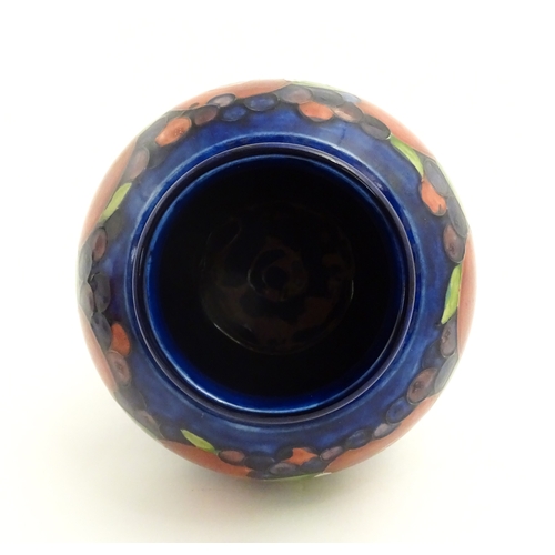 112 - A Moorcroft ginger jar decorated in the Pomegranate pattern. Marked under. Approx. 9 3/4