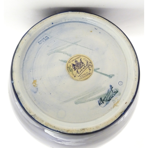 112 - A Moorcroft ginger jar decorated in the Pomegranate pattern. Marked under. Approx. 9 3/4