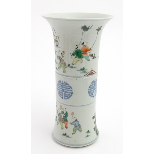 57 - A Chinese famille verte vase of Gu form decorated with figures, children playing and flying kites. A... 