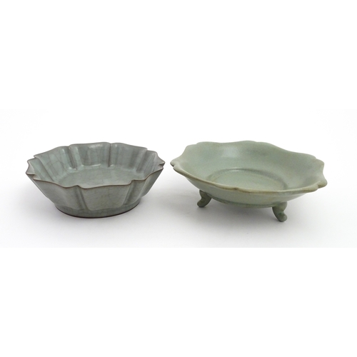 59 - Two Chinese celadon bowls / dishes of stylised lotus leaf form with crackle glazes, one raised on th... 