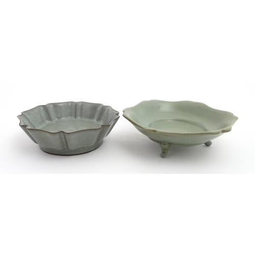 59 - Two Chinese celadon bowls / dishes of stylised lotus leaf form with crackle glazes, one raised on th... 