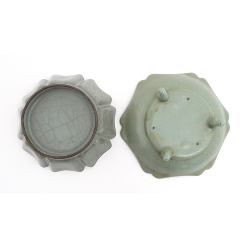 59 - Two Chinese celadon bowls / dishes of stylised lotus leaf form with crackle glazes, one raised on th... 