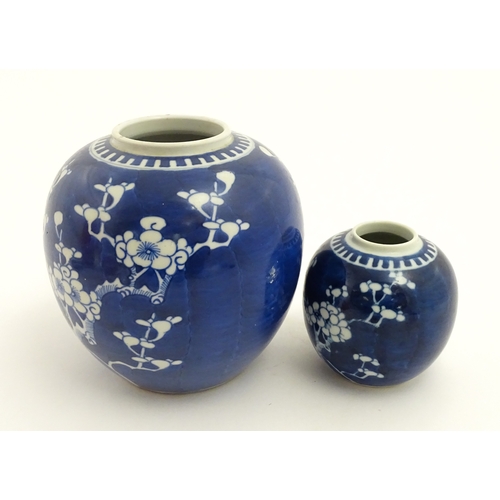 67 - Two Chinese blue and white ginger jars with prunus blossom detail. Largest approx. 6 1/2