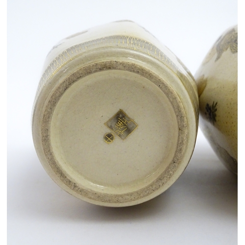 68 - A pair of Japanese Satsuma vases decorated with ladies and blooming wisteria. Character marks under.... 